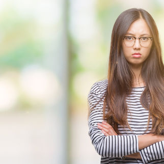 A visibly annoyed woman with her arms crossed