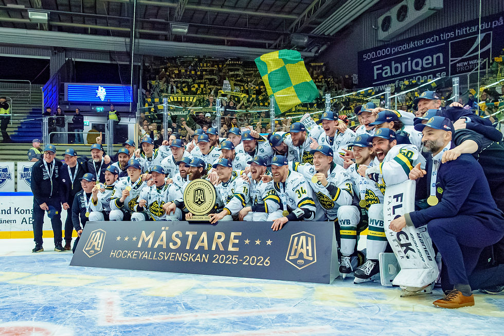 Hockey team celebrates on ice holding a gold trophy. Players wear white and blue uniforms with caps. Banner reads "Mästare 2025-2026."