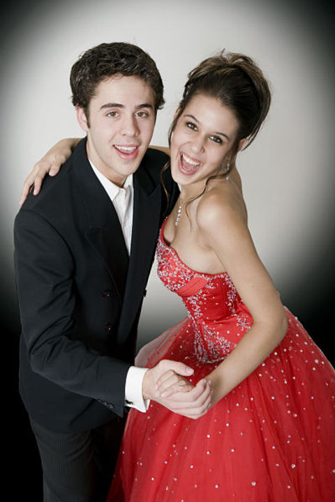 a young man and woman in dance hold, smiling