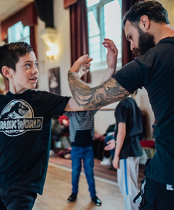 young boy learning to dance with teacher