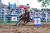 Cowgirl on horse barrel racing at Deepwell Farms Pro Rodeo