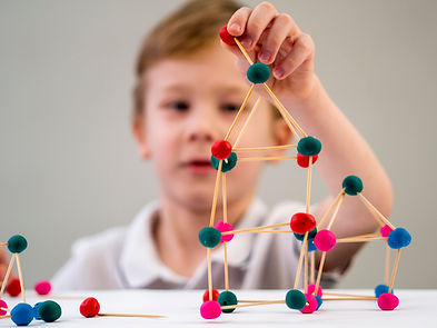 boy-playing-with-colorful-atoms-game-table.jpg