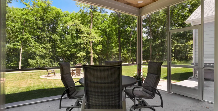 Elegant screen room on the patio of a custom home by Cloke Custom Homes in Porto Cima, offering a stylish outdoor retreat.