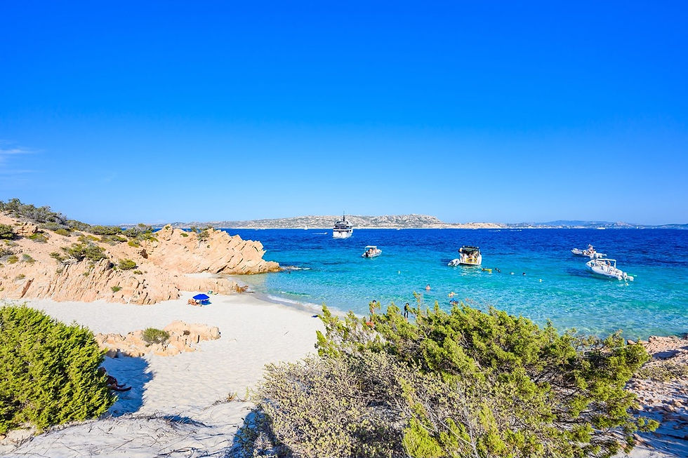 Cala Coticcio on Caprera Island, in Sardinia’s La Maddalena Archipelago, is a secluded cove known as “Tahiti,” where brilliant turquoise waters meet striking pink granite rock formations