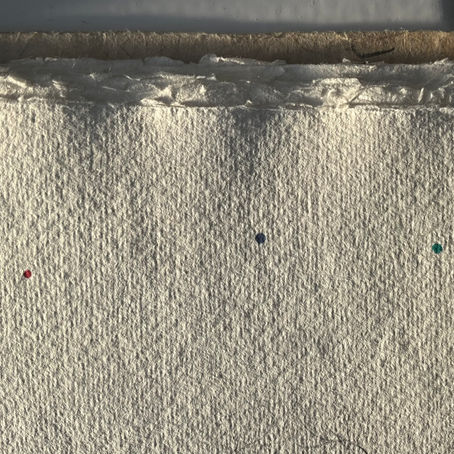 Three dots on cotton paper