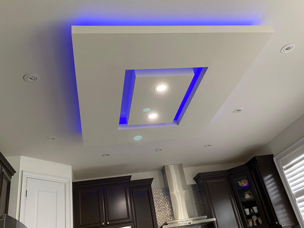 Custom ceiling feature with blue LED accent lightning and geometric recessed design