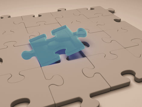 A blue green puzzle piece fitting perfectly in the middle of already connected tan puzzle pieces