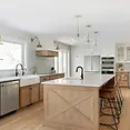 Open-concept kitchen renovation with quartz island and pendant lights