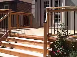 Sturdy wood deck with custom stairs and black metal railing in London, Ontario.