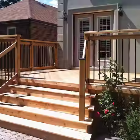Sturdy wood deck with custom stairs and black metal railing
