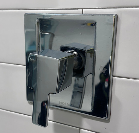 Clean and polished chrome shower fixture after professional cleaning