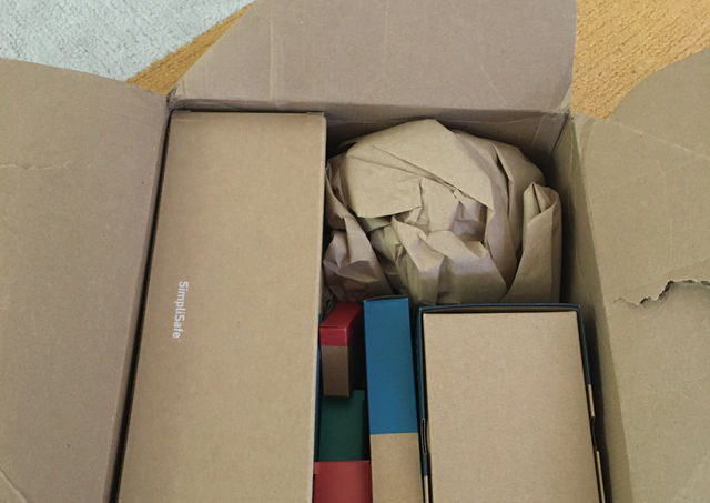 An open cardboard box with other smaller boxes inside.
