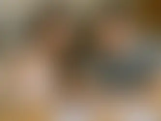 Glückliche junge Familie mit Neugeborenem beim Ausfüllen von Formularen am Küchentisch