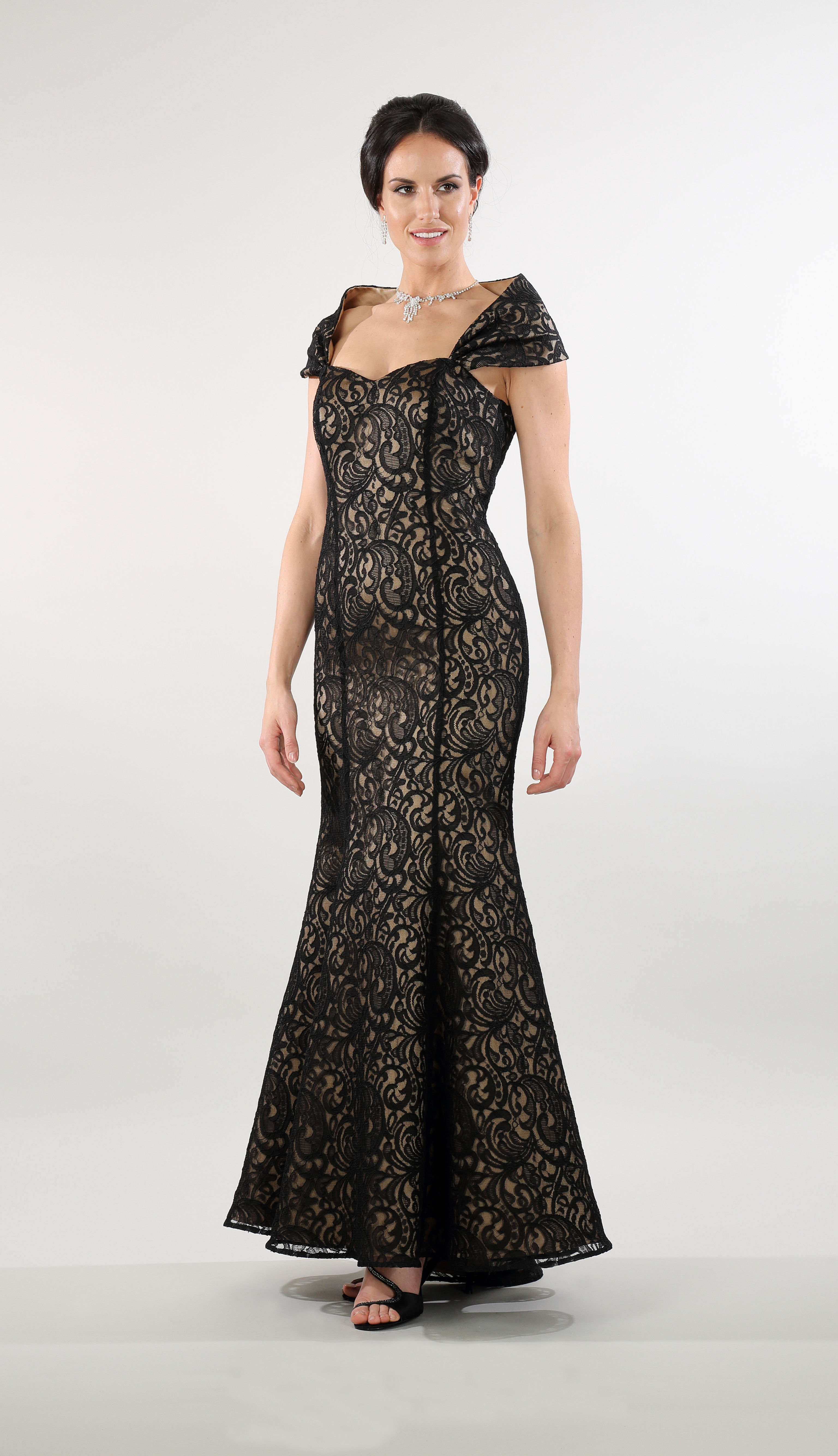 A high fashion model wearing a Lorellana Couture Mother of the Bride dress