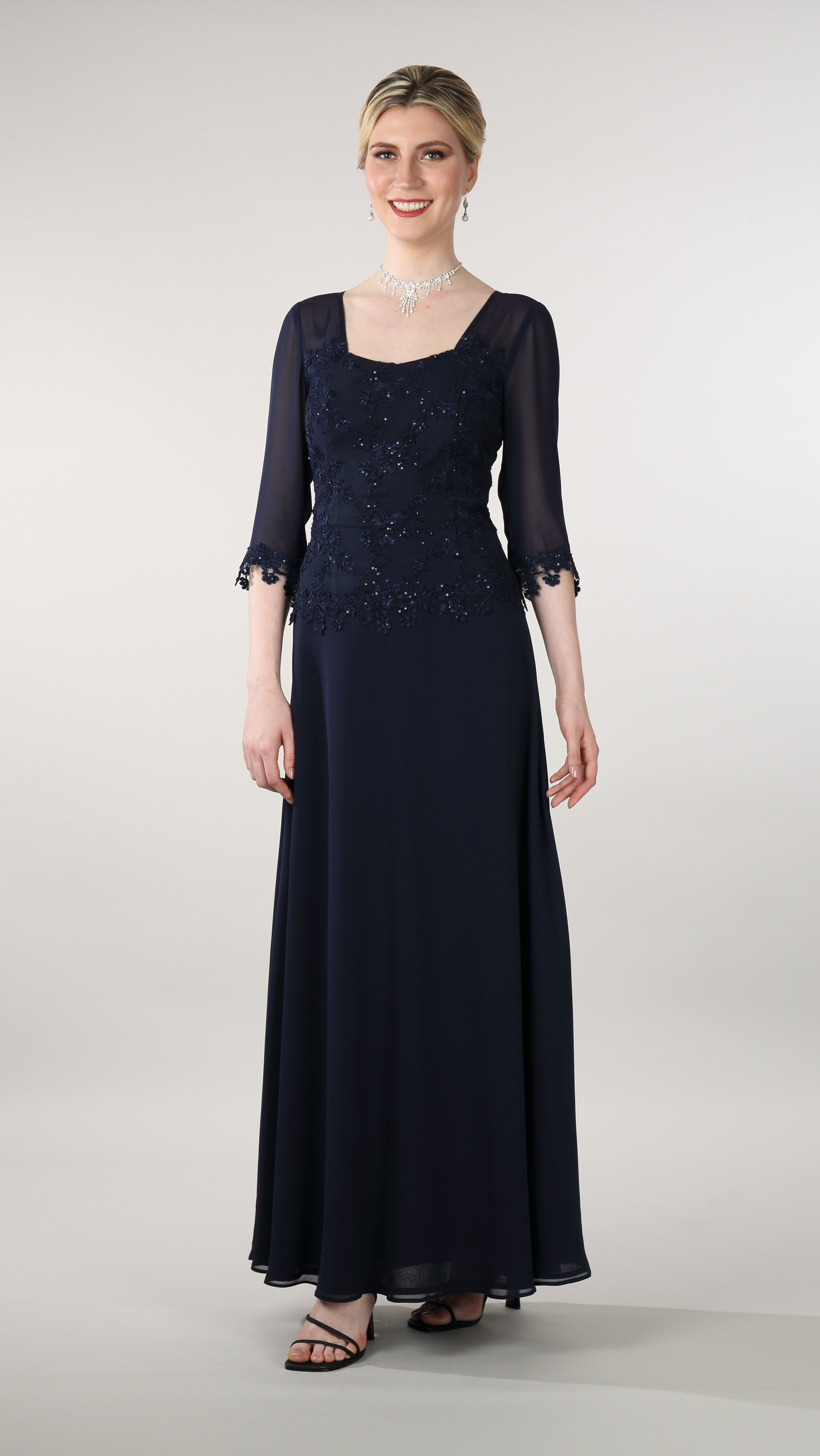 A high fashion model wearing a Lorellana Couture Mother of the Bride dress