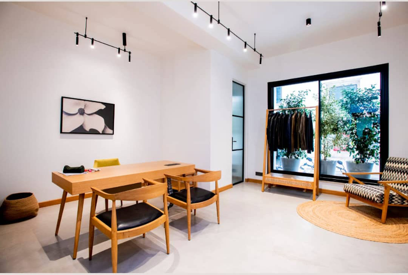 Japandi themed office with track lights and Oak furniture. Scandinavian style.