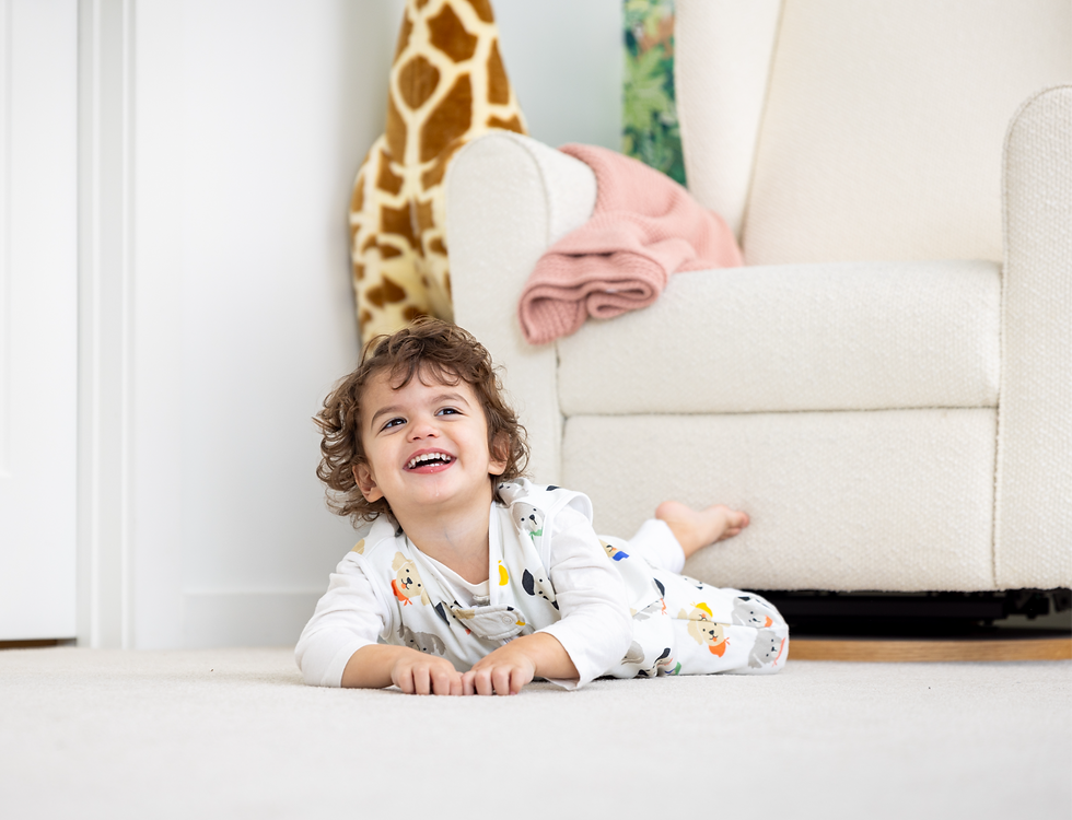 Eye-level view of toddler wearing a stylish organic cotton wearable blanket