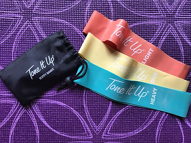 Tone It Up workout bands on a yoga mat