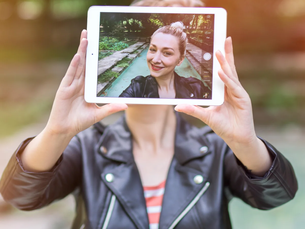 "A girl looking at perfect Instagram photos while feeling sad and overwhelmed in real life."