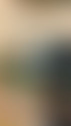 Camera on a tripod focusing on blurred people and string lights in a festive outdoor setting. Warm and inviting atmosphere.