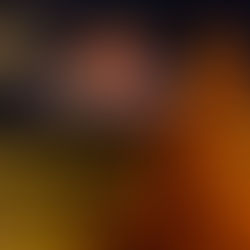 Striped orange-and-black legs crossed on a couch with a remote, watching a spooky pumpkin face on TV in a cozy dark room.