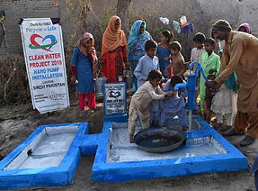 People using a newly constructed water well installed by Purpose of Life Charity