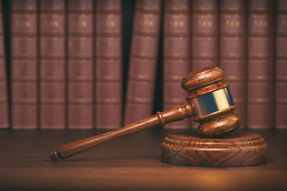 Gavel on a wooden desk with law books in the background