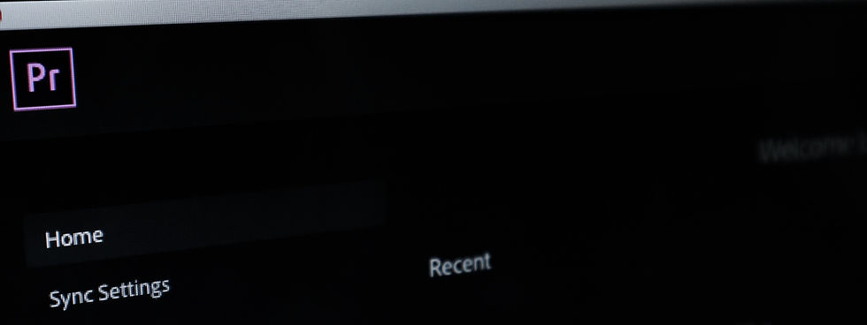 Dark computer screen with Adobe Premiere Pro icon. Visible text: Home, Sync Settings, Recent. Sparse light creates a focused, calm mood.