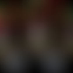 Three frosted bottles with red caps, adorned with festive wreaths and ornaments, set against a backdrop of colorful bokeh lights. Holiday mood.