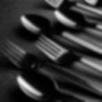 Black plastic forks and spoons