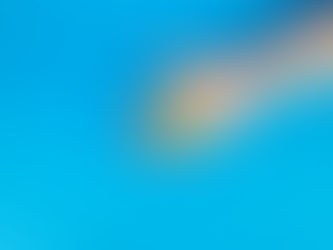 Hand holding assorted colorful pills on a bright blue background, creating a vibrant and health-focused visual.