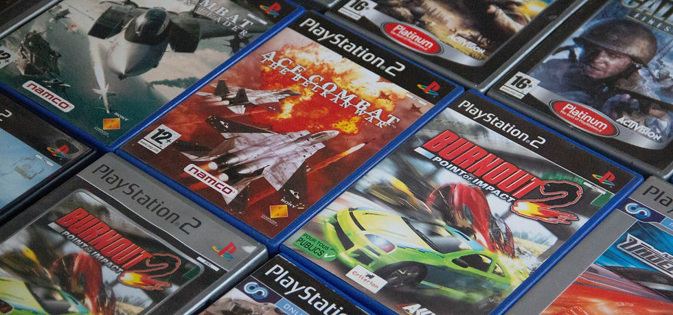 Assorted PlayStation 2 game cases laid out in a grid, with titles like Ace Combat, Burnout 2, and SOCOM visible.