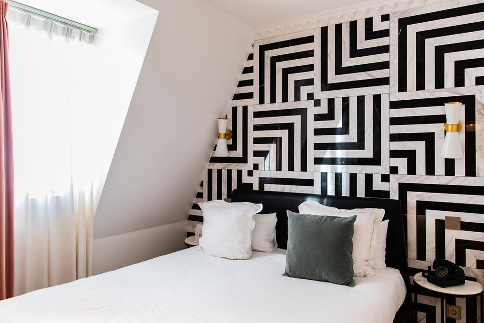 Stylish hotel room with black and white geometric wall design