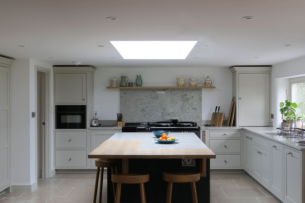 A handcrafted, bespoke shaker kitchen with calm neutral cabinetry, a blue statement island with a bespoke oak worktop and bespoke kitchen features throughout the design
