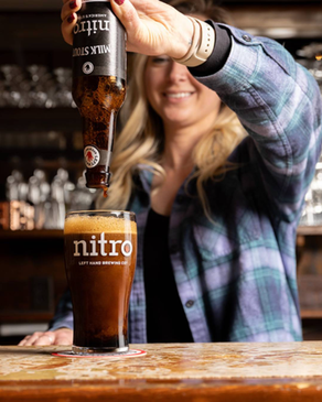 Left Hand Nitro Milk Stout poured from a bottle.