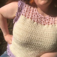 Woman wearing handmade crochet top in cream and lilac crochet details