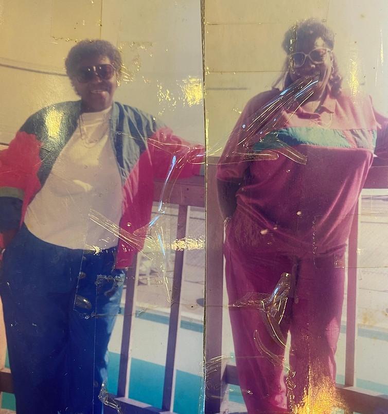 Two photos cut and taped together. Eleanor is on the left, smiling, leaning on a railing outside in the Poconos. Audrey is on the right in the same pose.