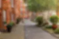 A street lined with tall brick buildings next to trees