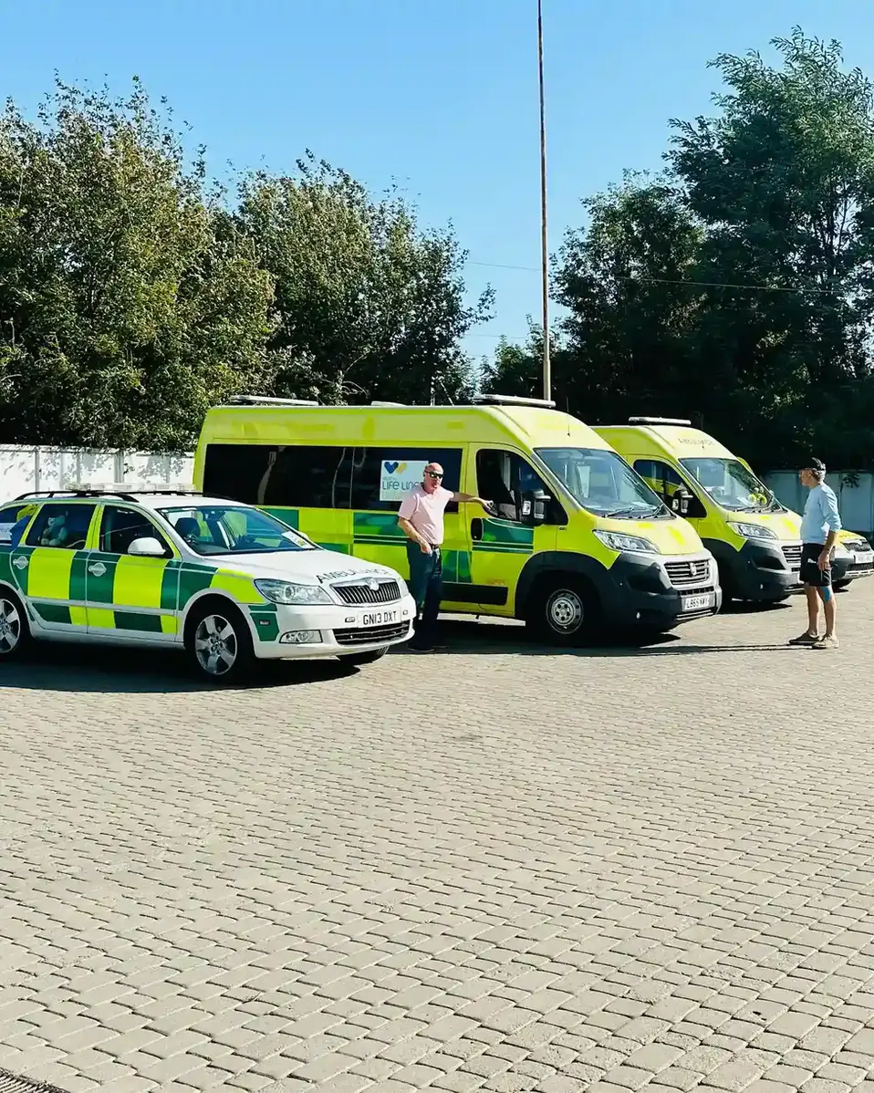 A group of ambulances parked in a parking lot