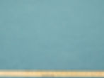 Cast in Lagoon high-performance blue indoor/outdoor fabric shown close up, highlighting its woven texture and durable quality
