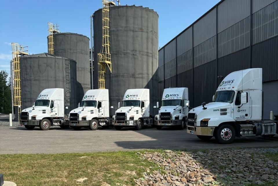 Five Municipal Waste Hub semi trucks in front of the upgraded facility in Hampden, Maine