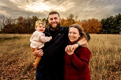 mom and dad posed with child