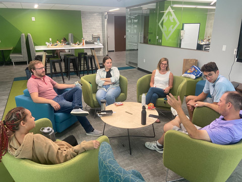 StartingBlock members networking in a circle in the lounge area.