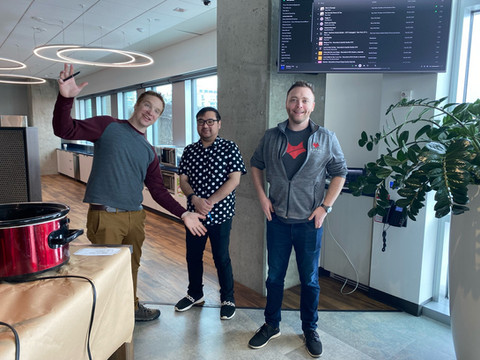 Three male StartingBlock members smiling for a picture in the Café for a community event.