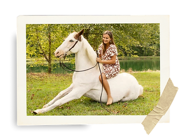 Emily Parker riding a white horse, enjoying a lesson or camp at SaddleRock Farm.