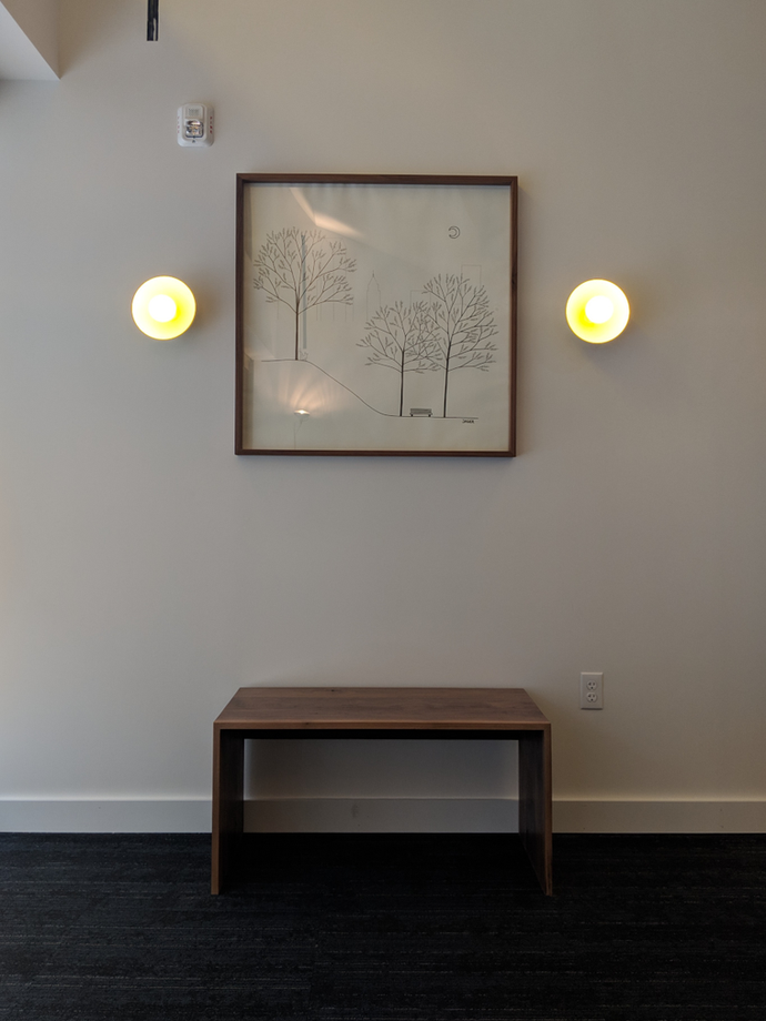 Bench and framed artwork in lobby