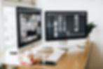 An iMac and external monitor with webdesign apps on them