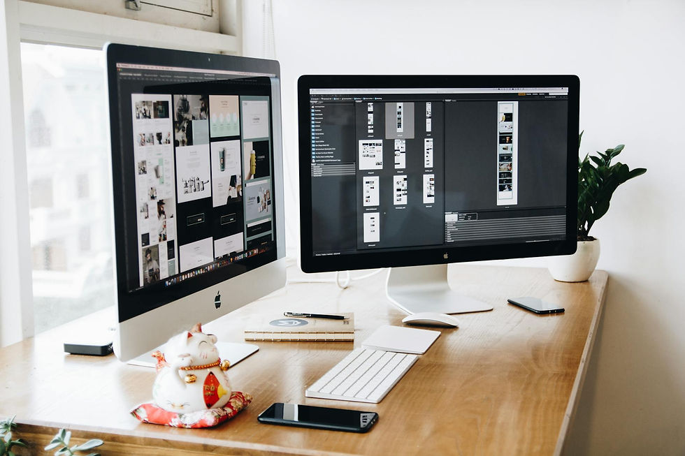 An iMac and external monitor with webdesign apps on them