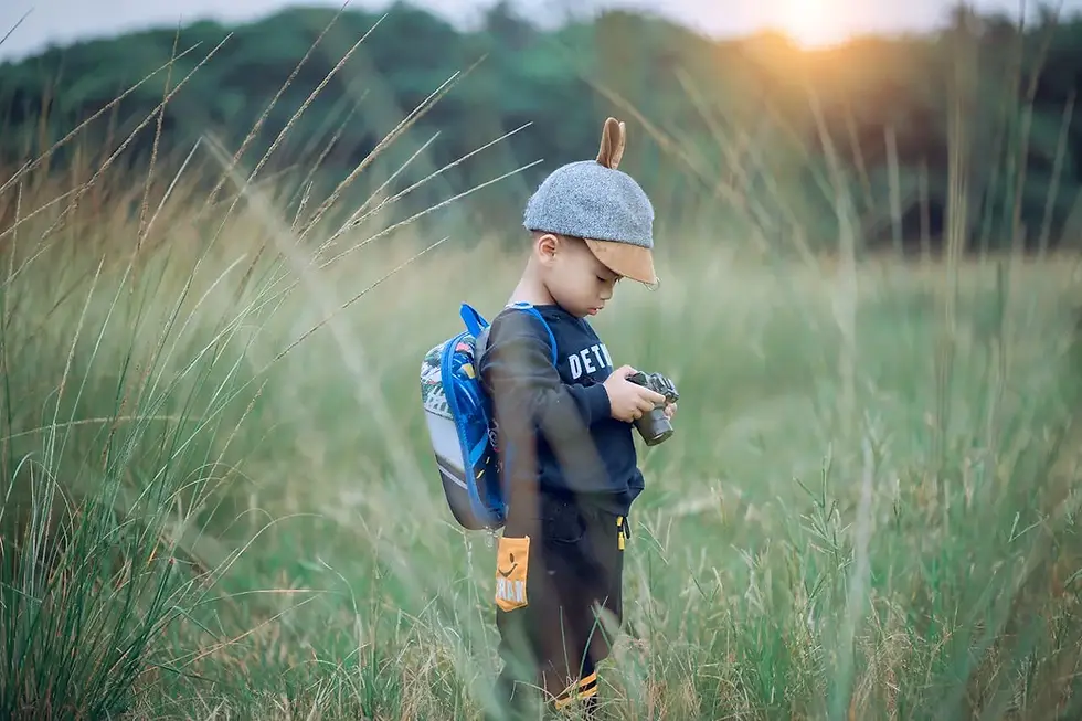 kid looking at a camera with backpack