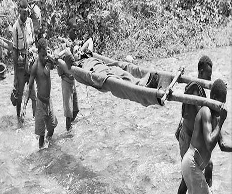 Kokoda Track. Wounded being brought in by native bearers 1942 PNG